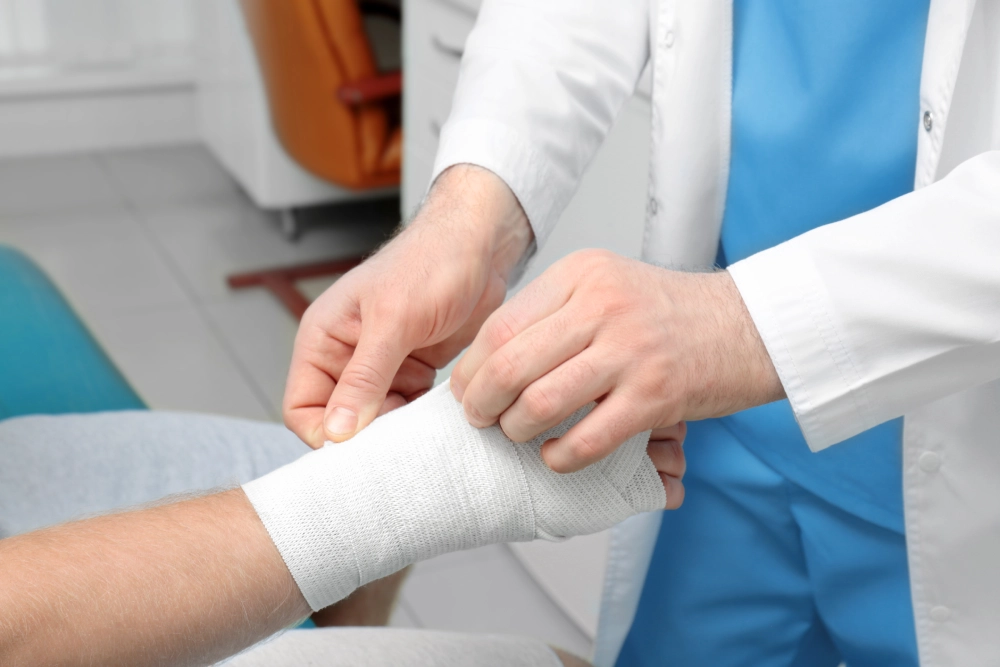 orthopedist-applying-bandage-onto-patients-hand-clinic-closeup